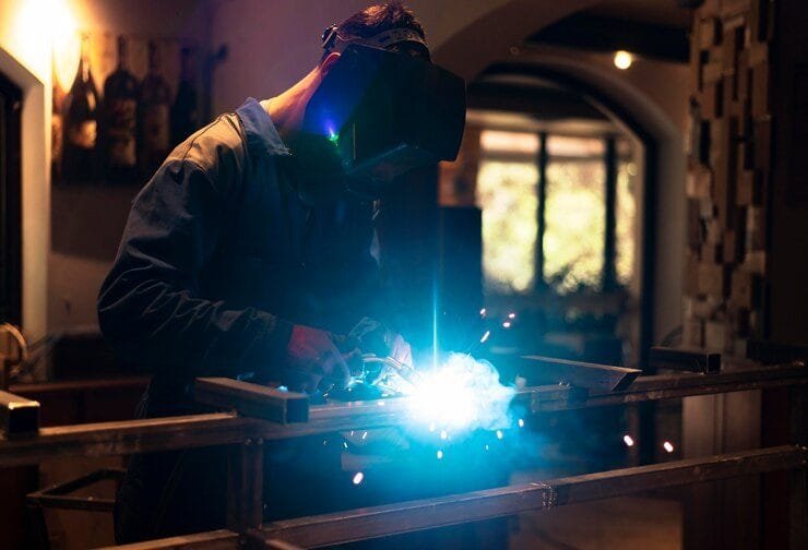 man-with-mask-welding-metal-atelier_23-2149025927